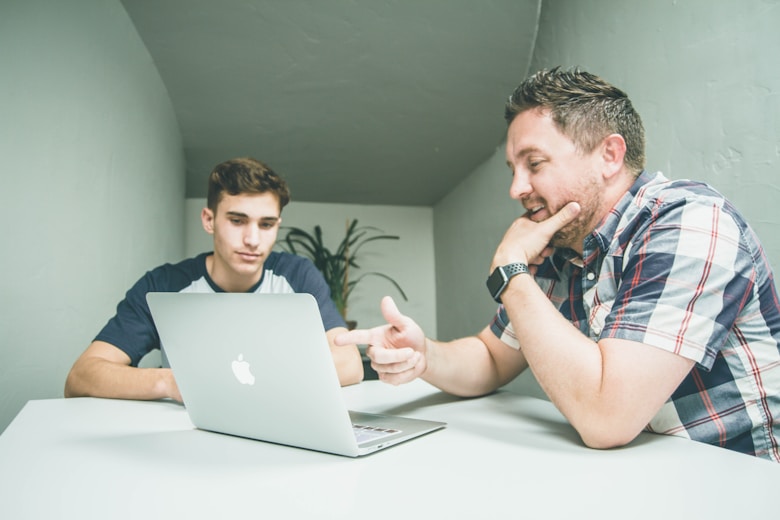 Two people working on laptop